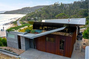 Modern coastal house with native green roof and corten steel terraces overlooking ocean at Separation Creek Victoria