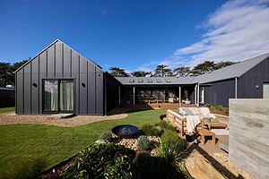 Modern landscape courtyard with mature Bottle Tree, Pickleball court and fireplace at Daylesford House 5, The Block