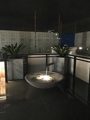 Custom fire bowl on St Kilda rooftop terrace with city views and contemporary outdoor furniture