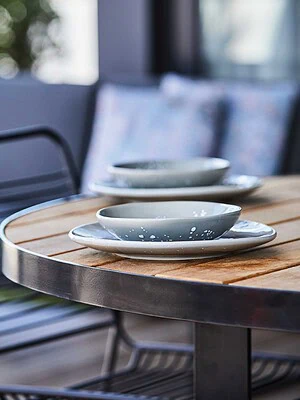 Custom timber dining table with ceramic tableware on St Kilda rooftop terrace from The Block