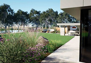 Curved concrete pathway through native plantings with outdoor kitchen pavilion in background at Mount Sturgeon Dunkeld