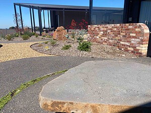 Curved exposed aggregate paths connecting contemporary home to landscaped garden areas in Gisborne Macedon Ranges